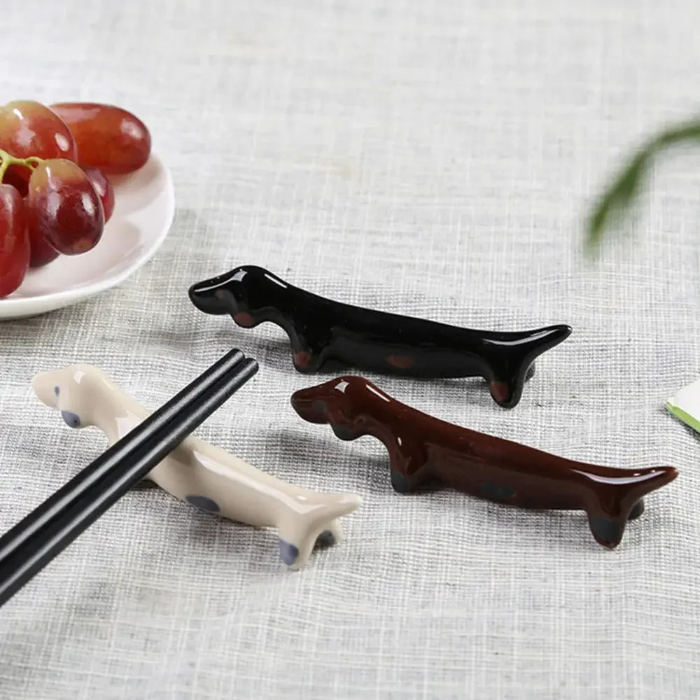 Three dog shaped kawaii chopstick holders on a table