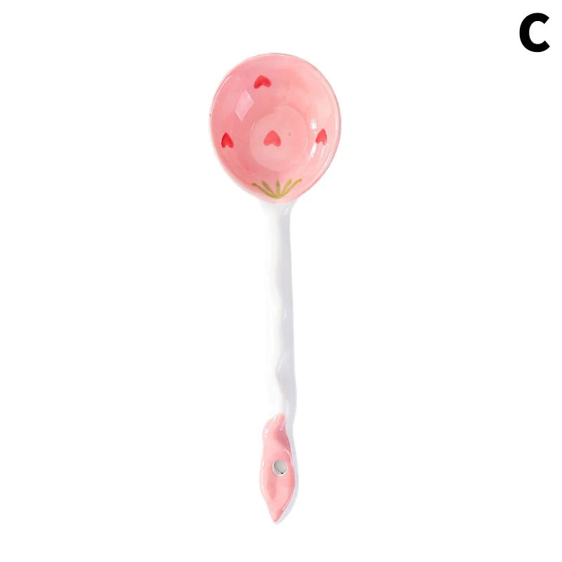 A strawberry and white kawaii spoons on a white background