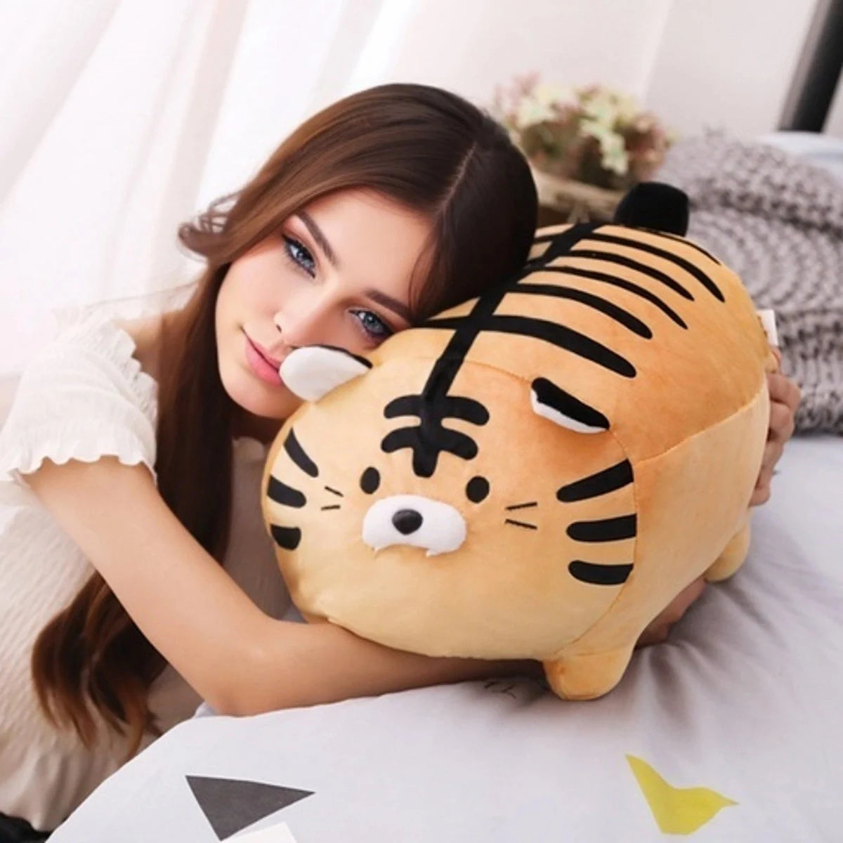 Woman holding a tiger-shaped kawaii plush toy in a cozy indoor setting