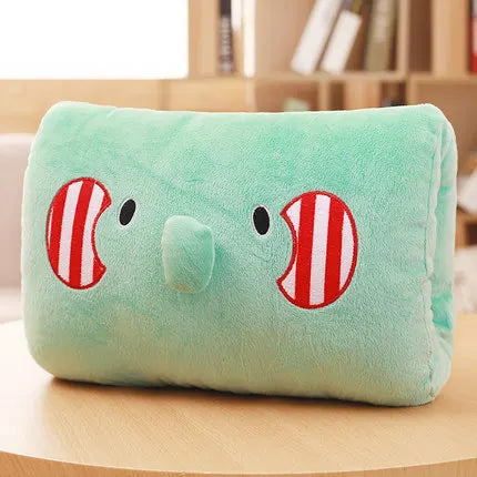 Green plush kawaii pillow with cartoon fish design on a wooden surface