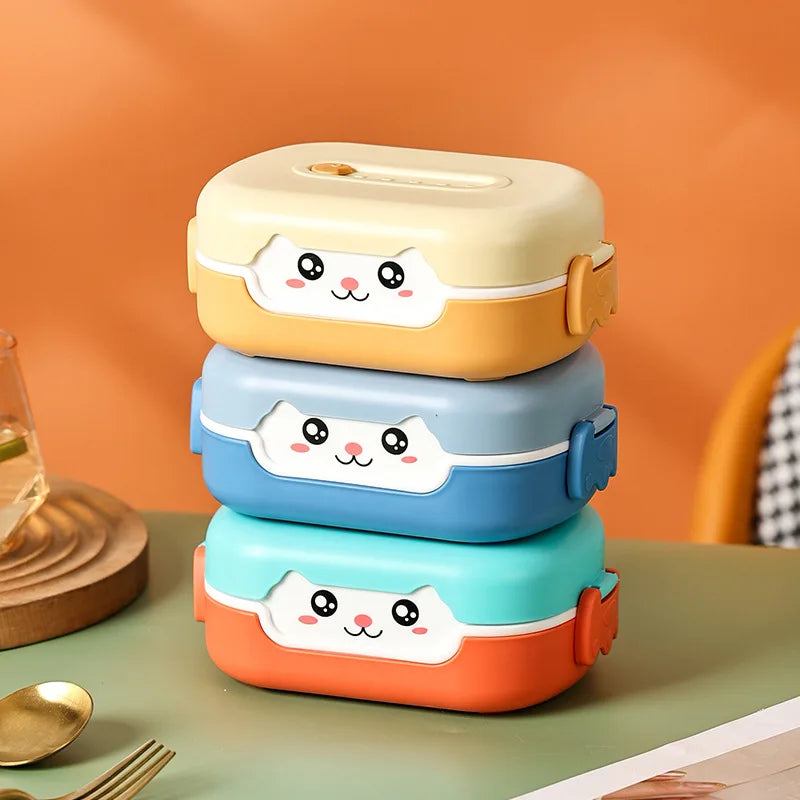 Stack of three colorful kawaii lunch boxes with cat face designs on a table.