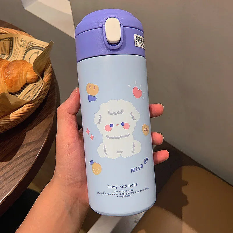 Light blue kawaii water bottle with purple lid held by a hand, featuring cartoon dog design.