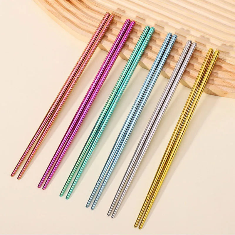 Set of colorful metallic kawaii chopsticks on a wooden surface