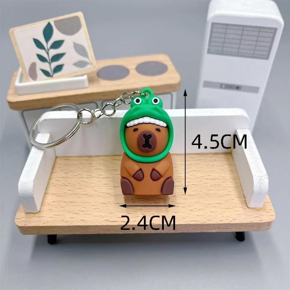 Keychain with kawaii bear design on a small wooden desk with measurements indicated.