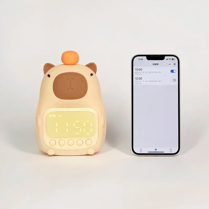 Cute animal-shaped kawaii alarm clock next to a smartphone on a white background