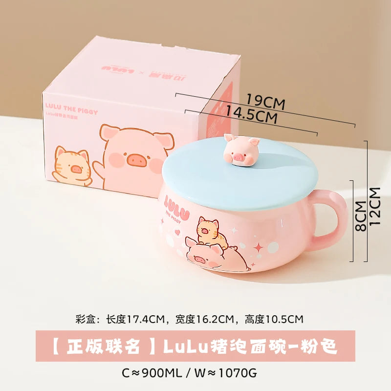 Pink kawaii ramen bowl with blue lid featuring a cartoon pig design, next to its packaging on a beige background.