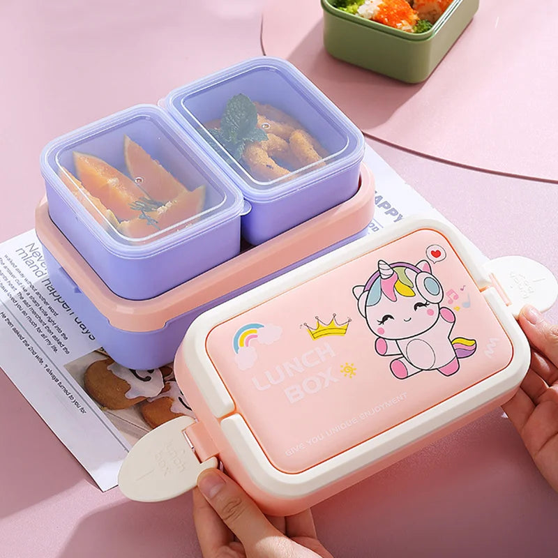 Pink kawaii lunch box with unicorn design held by a hand on a pink surface.