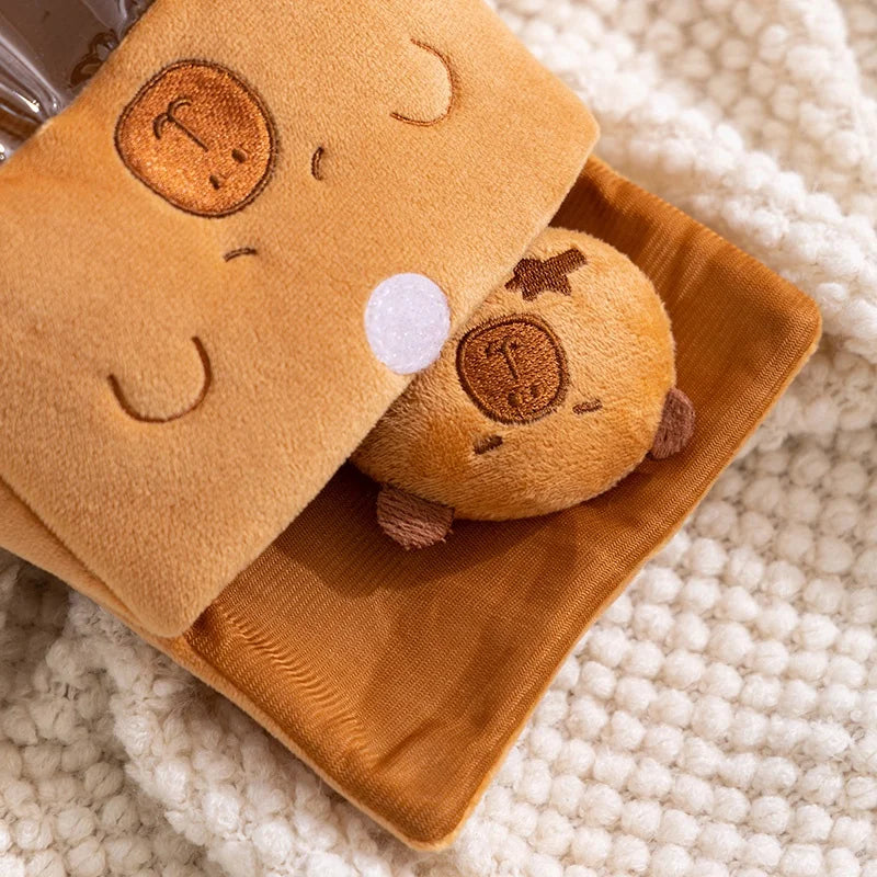 Kawaii plush toy resembling a sandwich with a face on a matching brown blanket on a textured surface.