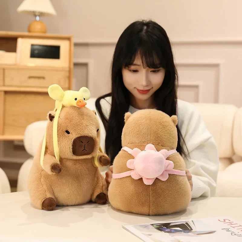 Woman sitting on a couch with two kawaii plush toys resembling bears.