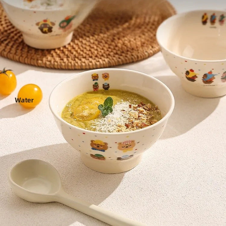 Kawaii ramen bowl of soup with a decorative spoon on a light surface