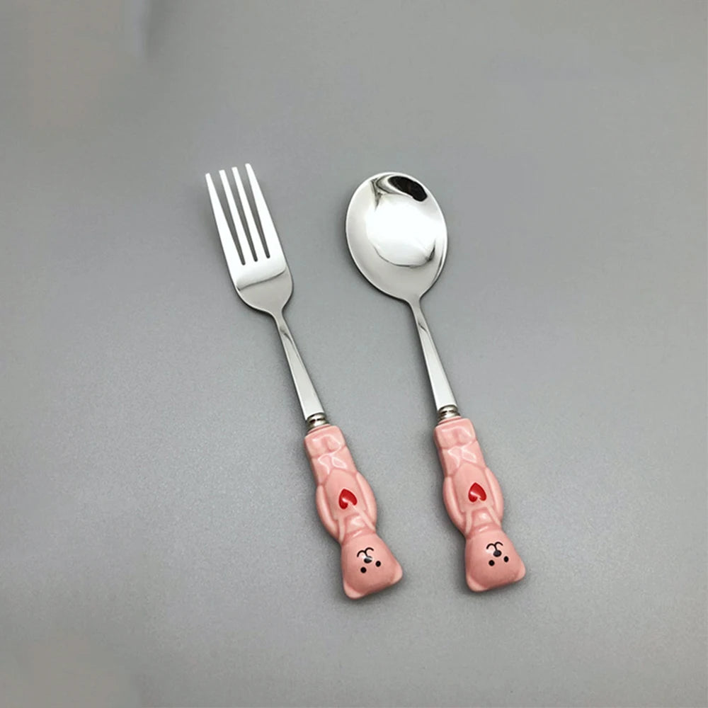 Bear shaped pink kawaii utensils on a gray background