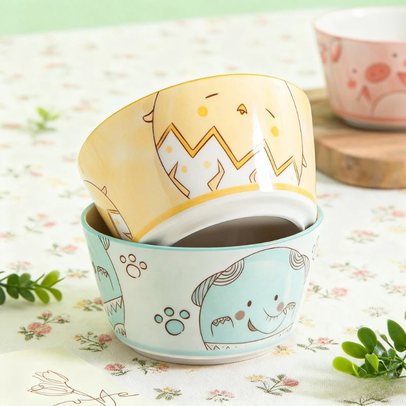 Ceramic kawaii bowls with elephant designs on a floral tablecloth