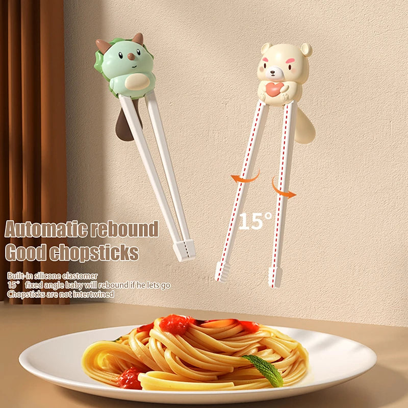Two cartoon animal-shaped kawaii chopstick holders on a beige wall with a plate of spaghetti below.