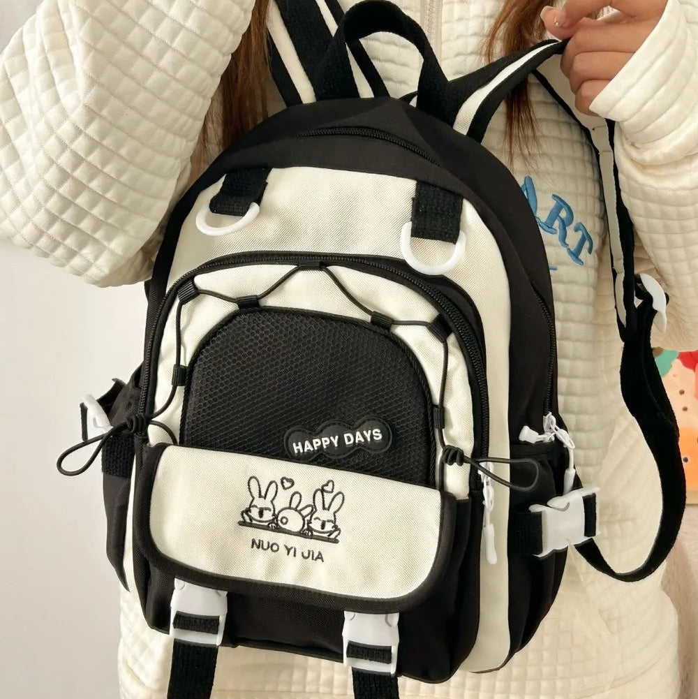 Person wearing a Kawaii white and black backpack with visible branding
