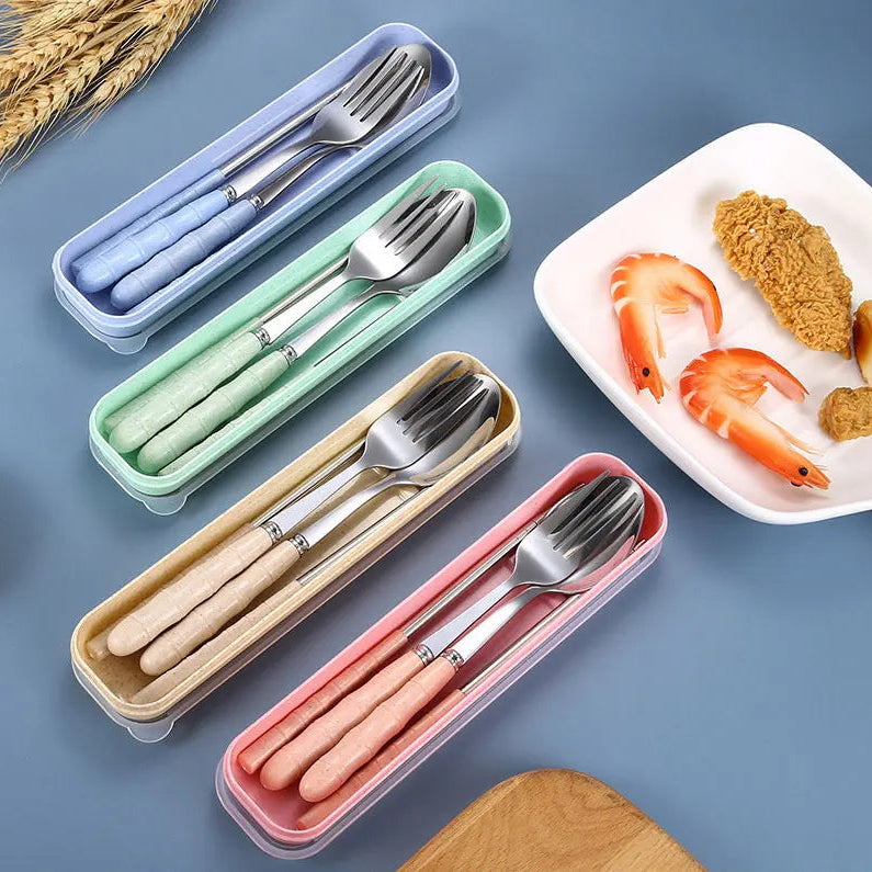 Set of silver kawaii utensils in colorful cases with a plate of food on a blue background