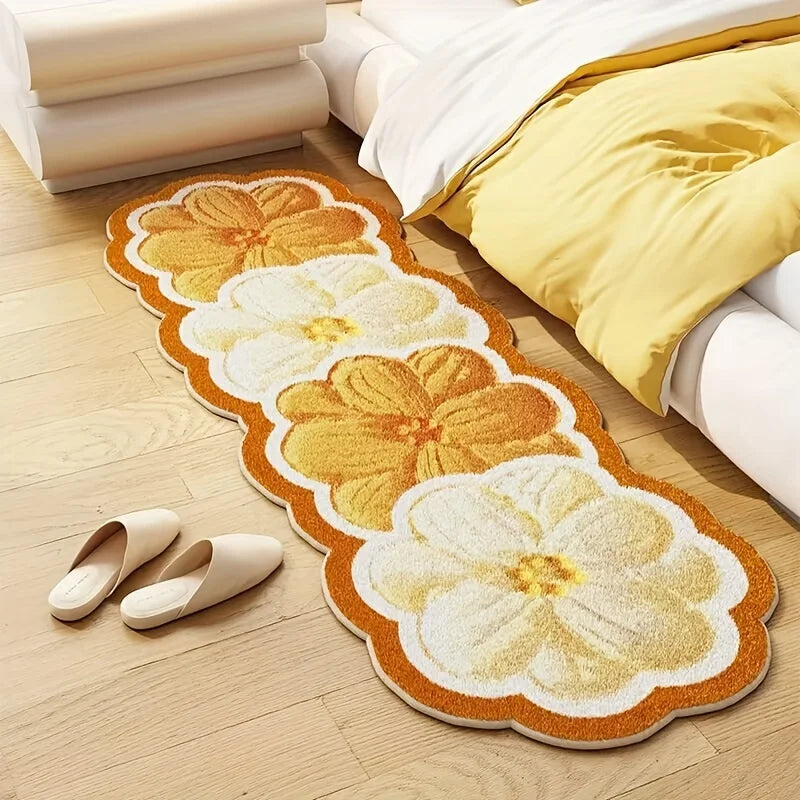 Floral patterned kawaii rug on a wooden floor with a bed and pillows in the background.