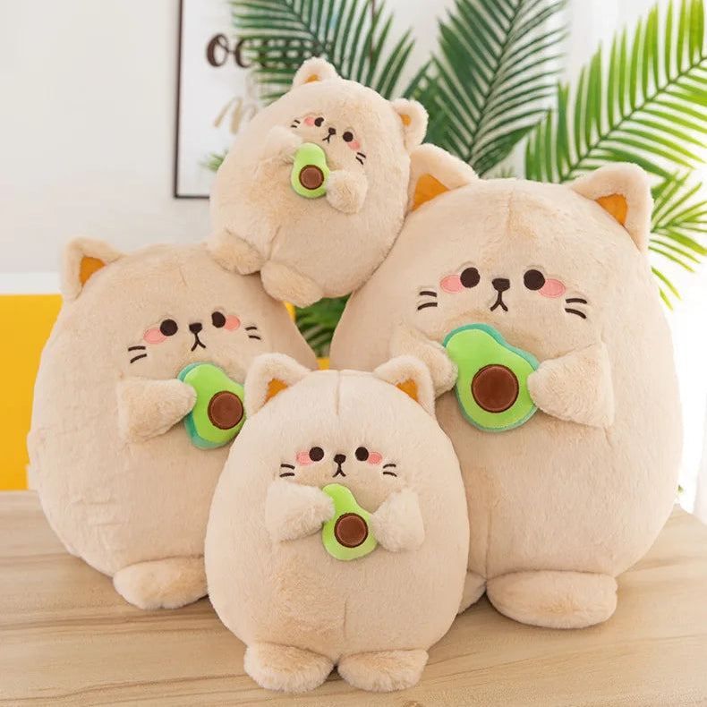 Four kawaii plush cat toys with green and brown accents on a wooden surface.