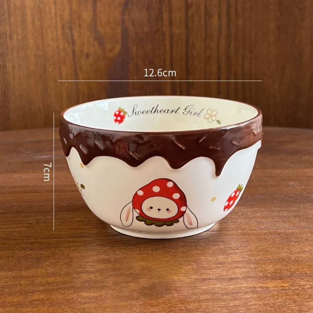 Ceramic kawaii ramen bowl with cartoon design on a wooden surface, featuring measurements.