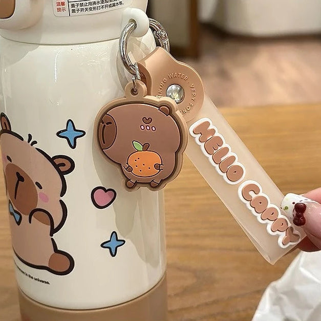 Cute cartoon bear kawaii mug with a matching keychain on a wooden surface