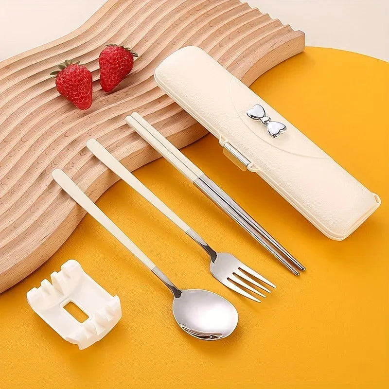 Set of silver kawaii utensils with beige handles on a yellow surface, including a carrying case.