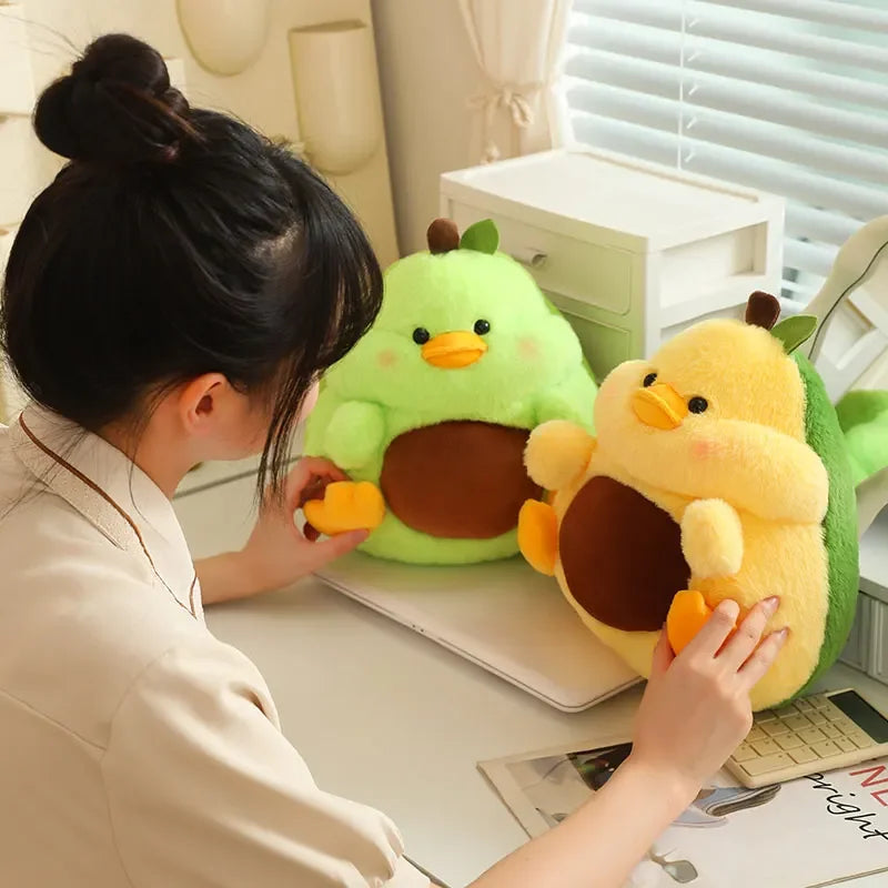 Person interacting with two kawaii plush toys resembling ducks on a desk.