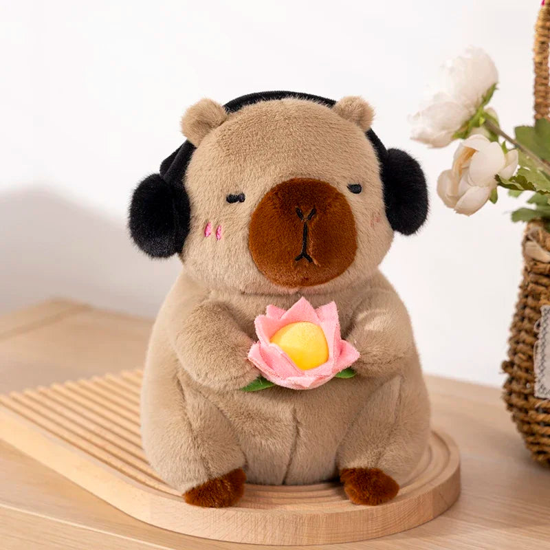 Kawaii plush toy pug with headphones holding a flower on a wooden stand