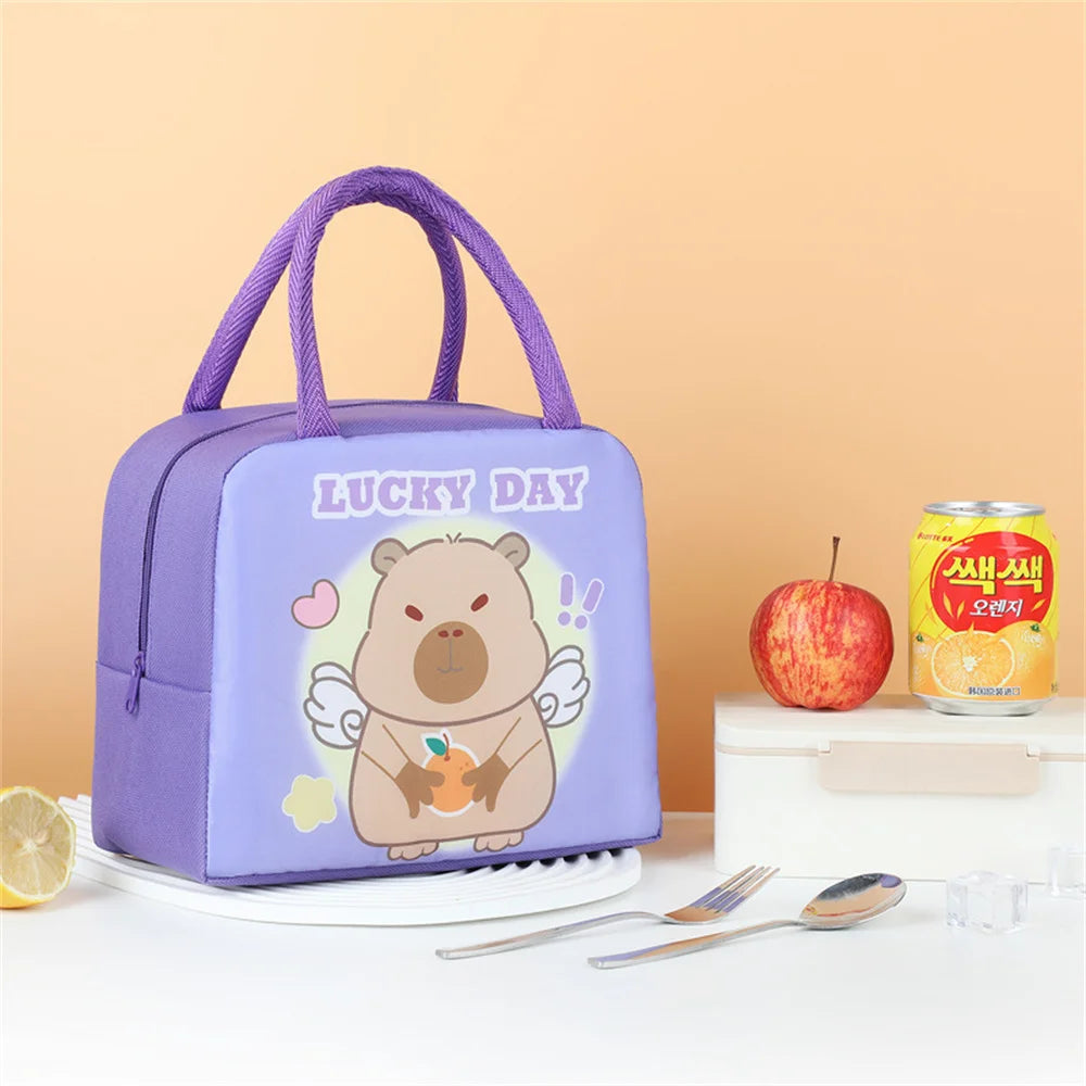 Purple kawaii lunch bag with cartoon bear design and 'Lucky Day' text on a table with food items.