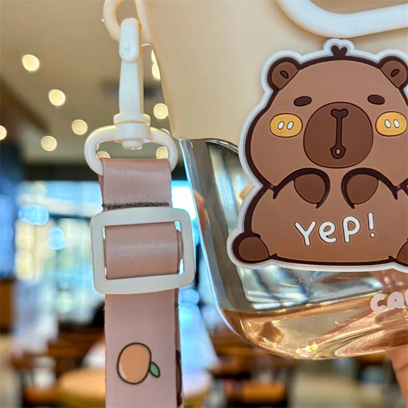 Kawaii capybara water bottle on a clear drink container with a pink strap.