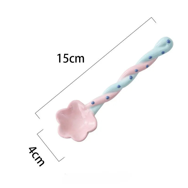 A pink and blue ceramic kawaii spoon on a white background