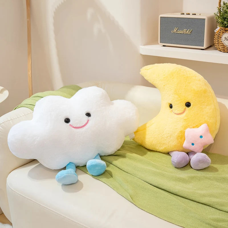 Kawaii plush toys shaped like a cloud, moon, and star on a couch with a radio in the background.