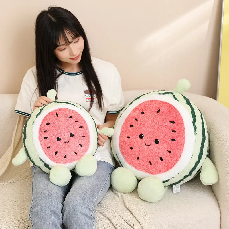 Person holding two kawaii plush watermelon toys on a couch
