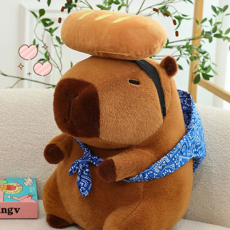 Kawaii plush toy bear with a loaf of bread on its head sitting on a couch.