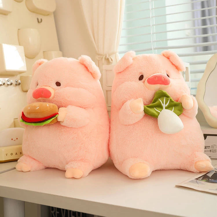 Two pink pig kawaii plush toys holding a hamburger and a radish on a desk.