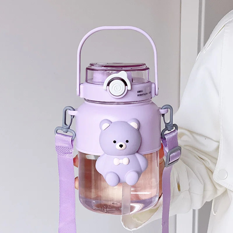 Purple kawaii water bottle with bear design and strap on a light gray background