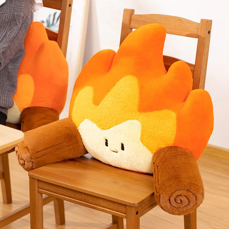 Flame-shaped kawaii cushion with a face on a wooden chair