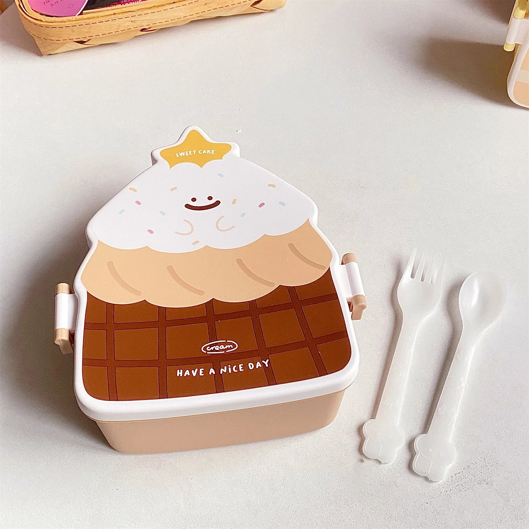 Ice cream-themed kawaii lunch box with utensils on a light surface