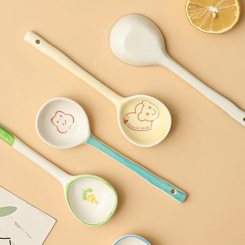 Four white kawaii spoons on a table