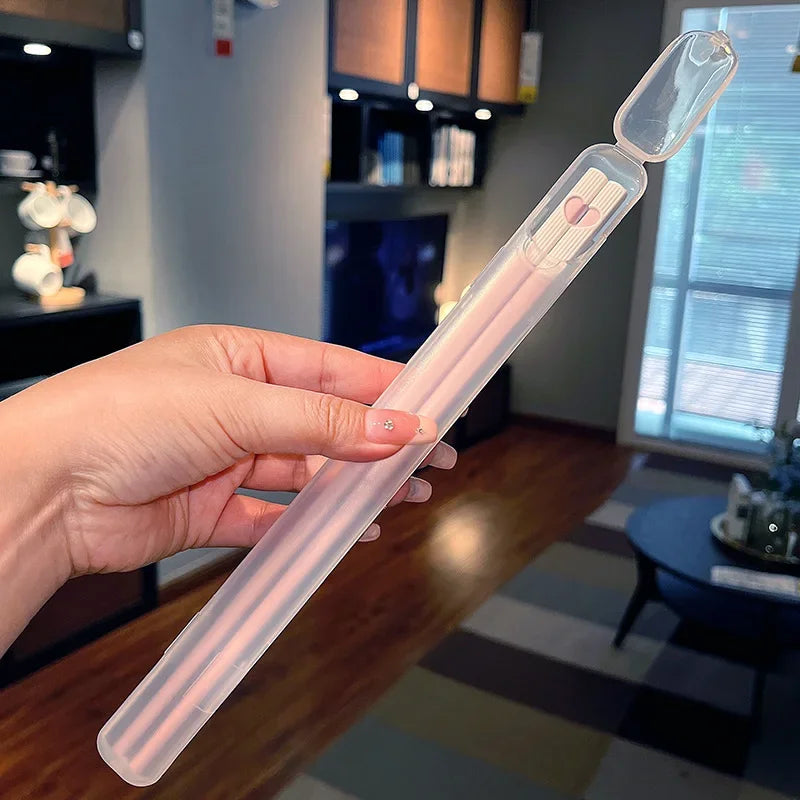 A person holding a kawaii chopsticks in an indoor setting