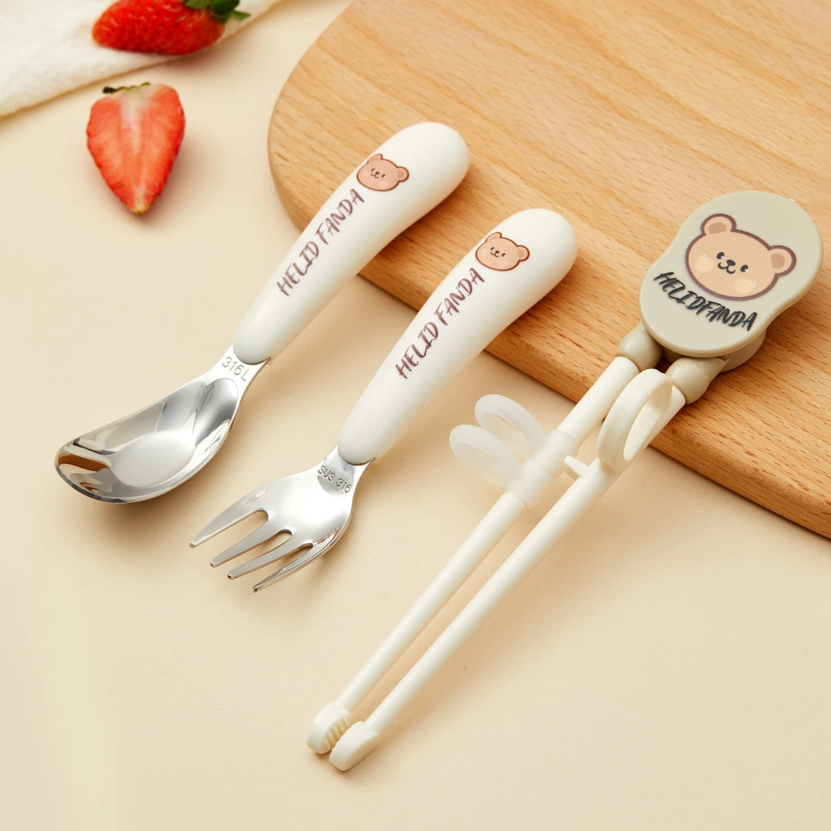 Children's kawaii utensils set with bear-shaped handles on a wooden surface