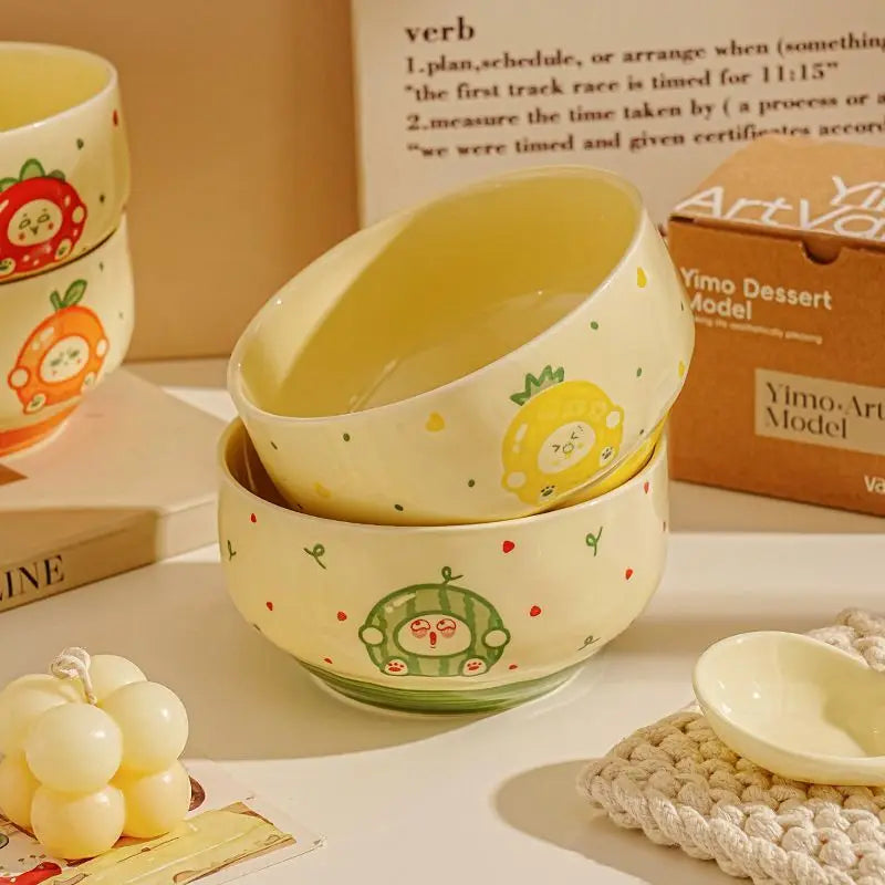 Two cartoon designed kawaii bowls stacked on a table