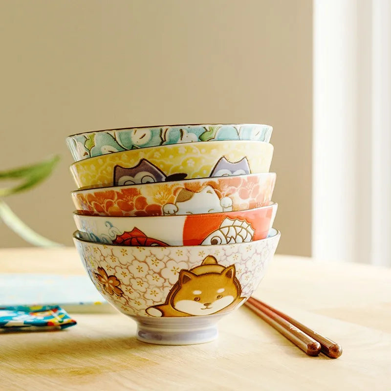 A stack of five kawaii bowls on a table