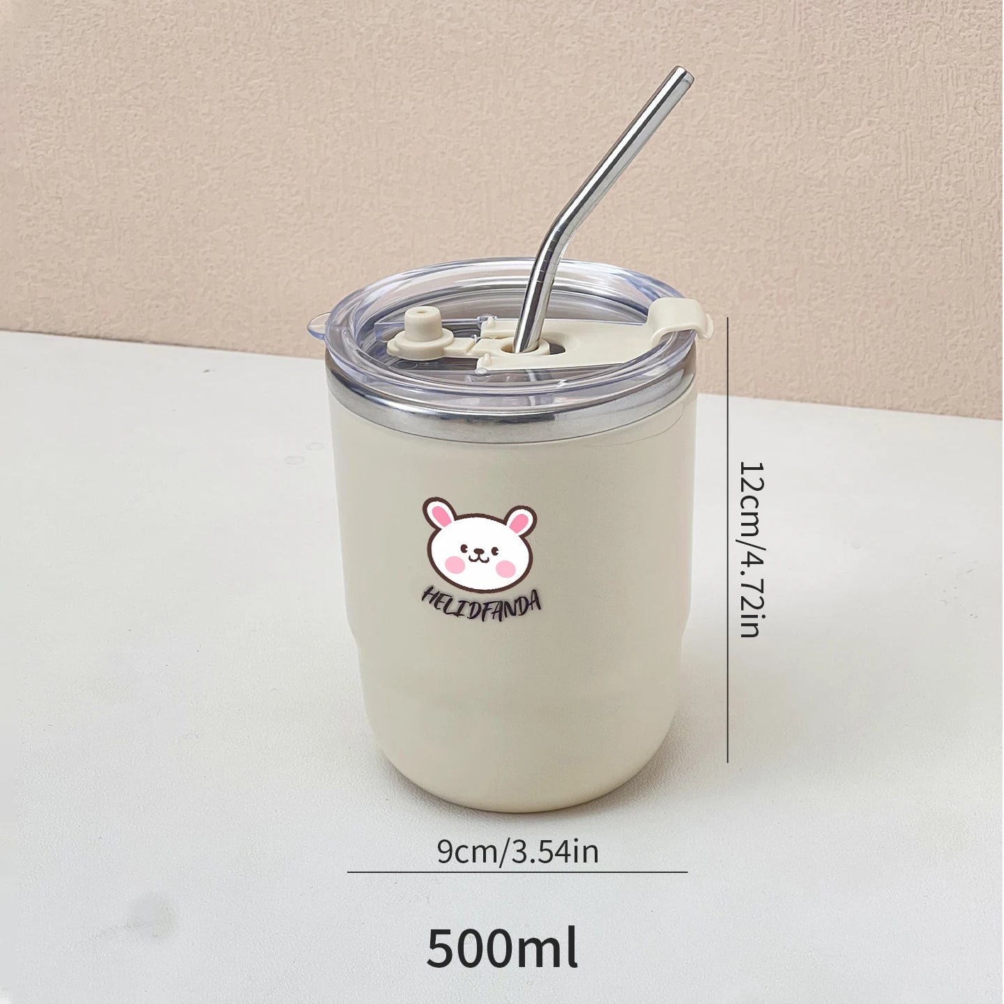 White kawaii tumbler with a straw and lid, featuring a logo, on a light surface with measurements displayed.