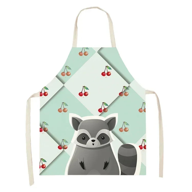 Children's kawaii apron with raccoon and cherry design on a light green background