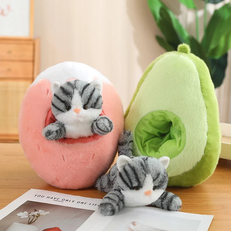 Two kawaii plush toys shaped like a pink ball with a cat and an avocado on a wooden surface.