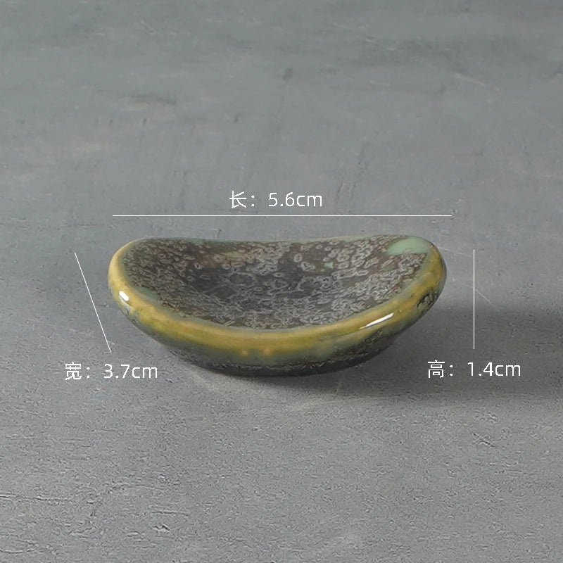 Small ceramic kawaii chopstick holders with dimensions on a gray background