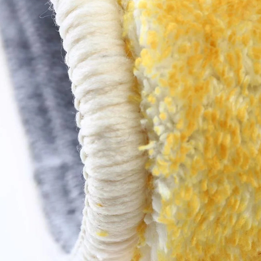 Kawaii rug with textured yellow and white fabric, featuring a small figure in red and black.