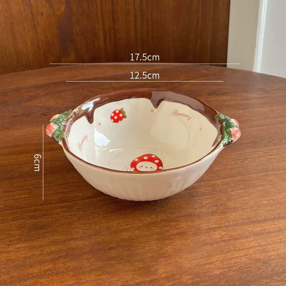 Ceramic kawaii ramen bowl with cartoon designs on a wooden table, showing measurements.