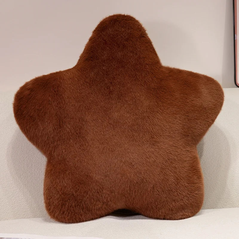 Brown star-shaped pillow on a light-colored couch