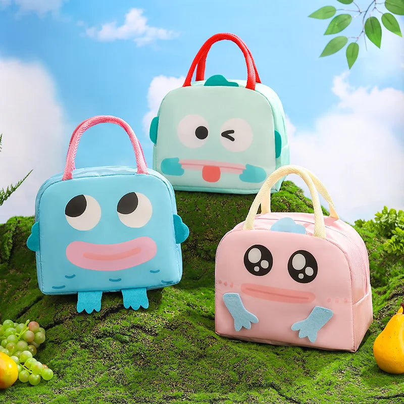 Three cartoon-style kawaii lunch bags on a natural background with greenery.