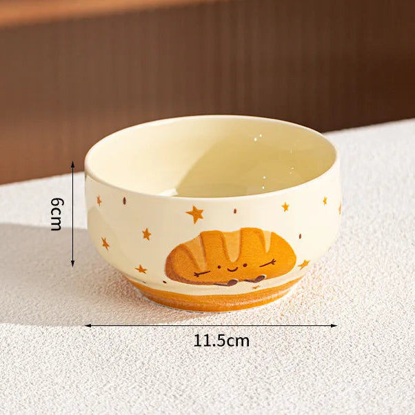 Ceramic kawaii bowl with bread design and measurements on a textured surface